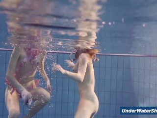 Horny girls strip eachother in the_pool