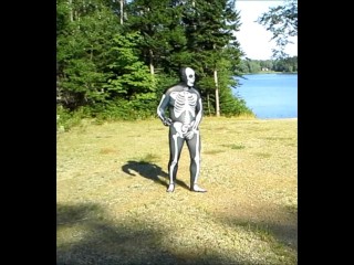 armed zentai skeleton outdoors in the sun