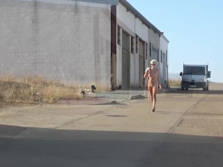 Naked blonde is walking in the Spanishcity.