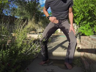 Pissing grey jeans in a_huge flood_outdoors