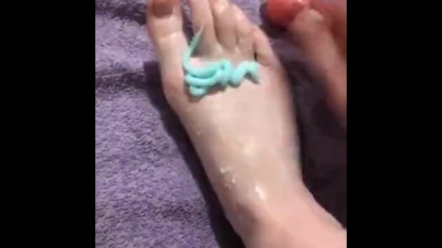 Young white girl rubs moisturiser over sore feet 4