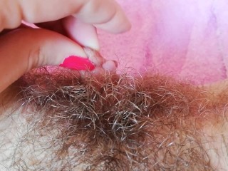 Playing with my big clit hood pulling_and stretching hairy bush pussy close