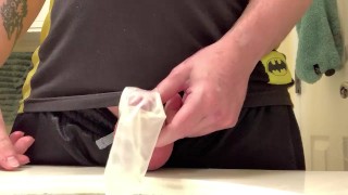 Horny Pissing In A Condom By A Hard Cock