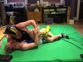 Tall jock wrestles and dominates blonde guy in singlet into holds