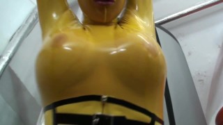 Handcuffs Girl Encased In Yellow Latex Catsuit Fishnets Bondages With Herself