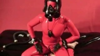Skinny Rubber Fetish Girl Masturbates In A Red Latex Catsuit And Gasmask