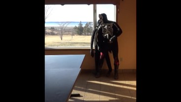 skeleton mask in tights and cowboys boots cums on dummy in front of window
