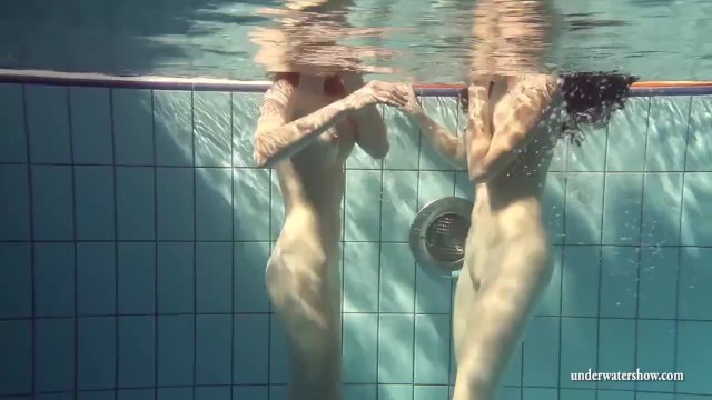 Mia and Petra undress eachother in the swimmingpool
