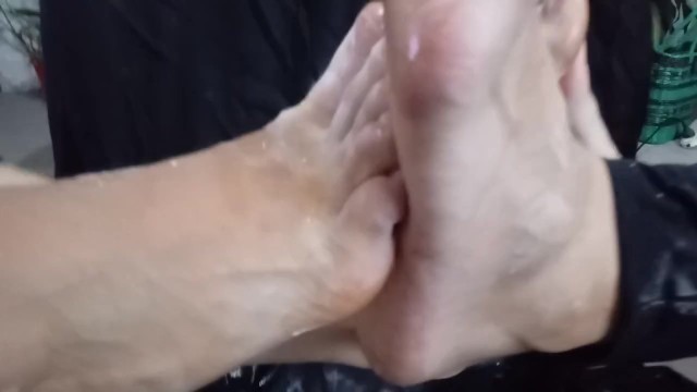 two girls big feet playing footsie with be er