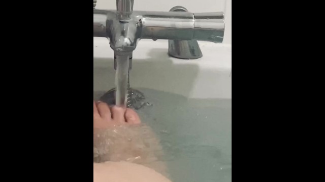 My feet in the bath playing with my rubber duck 13