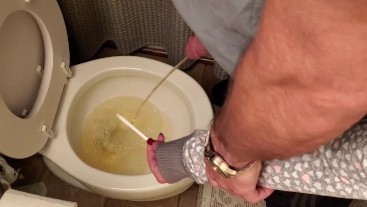 Holding my boyfriends cock while he pees in the toilet long pee ... photo