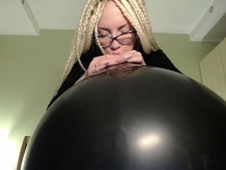 Blow big black balloon & pop with nails