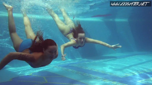 Two hot lesbian brunettes in the swimming pool
