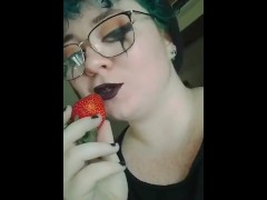 sucking on a strawberry
