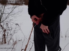 Russian guy walks in the snow near the river