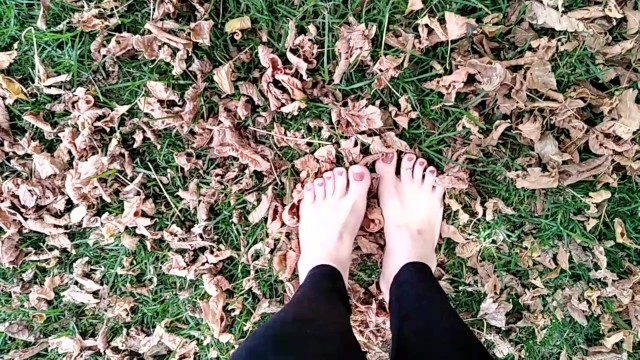 two sexy pairs of feet stepping on crunchy fall leaves