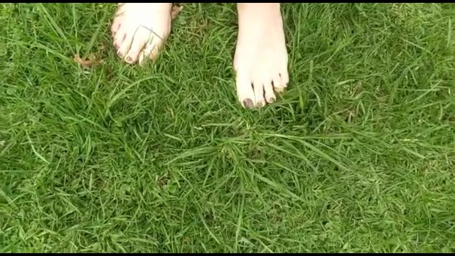 two sexy pairs of feet stepping on crunchy fall leaves