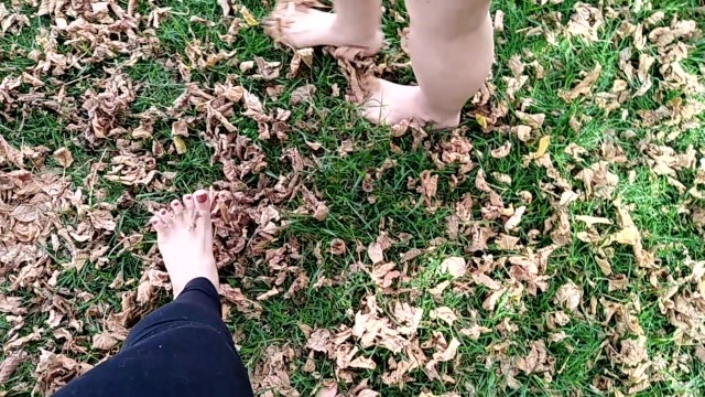 two sexy pairs of feet stepping on crunchy fall leaves