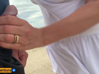 She loves to make a handjob on thecrowded beach