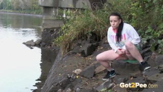 Raven Haired Girl Pees Near The River