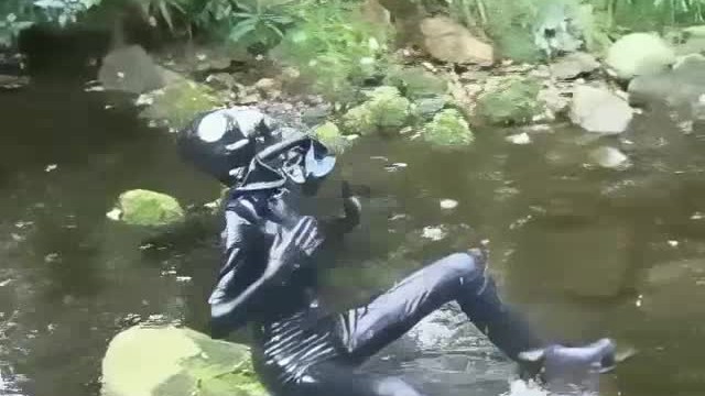Outdoor walk in the wood and river bath full encased in black latex catsuit and rubber gas mask 13