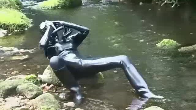 Outdoor walk in the wood and river bath full encased in black latex catsuit and rubber gas mask 13