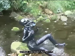 Outdoor walk in the wood and river bath full encased in black latex catsuit and rubbergas mask