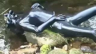 Latex Outdoor Walk In The Woods And River Bath While Wearing A Black Latex Catsuit And A Rubber Gas Mask
