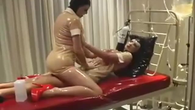 Hot rubber lesbians in transparent latex outfits and gas masks enjoys breath games in clinic room