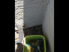 Peeing in a bucket outside