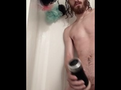 Young man in the shower with his toy