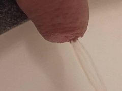 close up pee in sink. uncutted