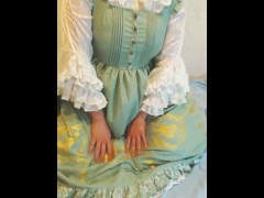 crossdresser wearing a green girly dress and sanitary towel