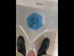 Pissing in a public urinal at work