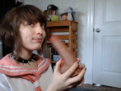 femboy schoolgirl gives a blowjob to his toy