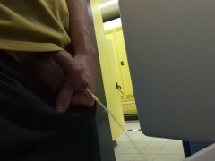 guy pissing at gym toilet