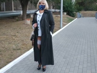 Slut walking in the park in a raincoat and black fishnet stockings_with a white elasticband