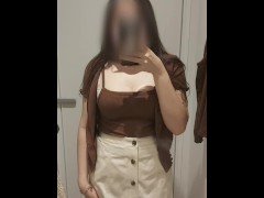 Asian girl trying clothes in fitting room