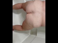 Mature peeing in toilet and shower 