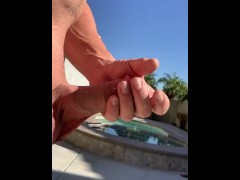 Stroking thick girthy cock by pool. 