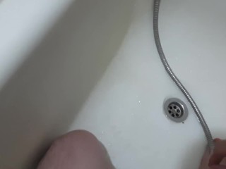 hotstudent washes in the shower and drains the piss while_sitting