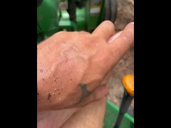 Dirty feet on tractor cutting wood