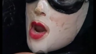 Girl with big boobs encased in black rubber latex catsuit enjoys bucket of hot cumm - part 2