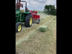 farmer joe pounding hay on tractor 