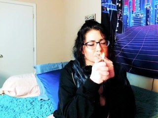 Smoking goth girl makes herself squirt