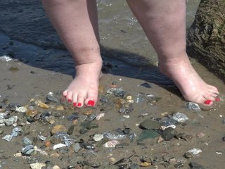 A Fat Woman With Big Feet Walks Along The Shore