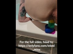 Slut fucks rainbow dildo in bath