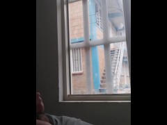 masturbating in the window facing the street