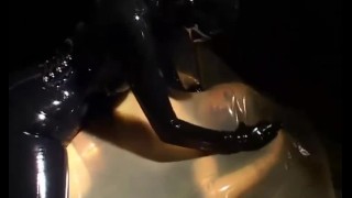 Two sexy lesbians full encased in latex suits have fun in her rubber skins and vacuum bed - Part 1