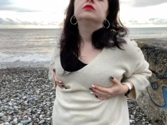 Hot Mistress Lara is playing with her big natural tits at the beach